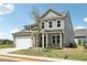 Attractive two-story home featuring a two-car garage, covered porch, and landscaped front yard at 3698 Annsbury Ct, Lilburn, GA 30047