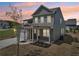 Two-story home with gray siding, brick accents, a covered porch, and mature landscaping at 3698 Annsbury Ct, Lilburn, GA 30047