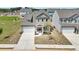New construction gray home with front-entry two-car garage and sidewalk at 3698 Annsbury Ct, Lilburn, GA 30047