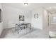 Neutral home office featuring a glass desk on a gray rug and a small storage closet at 3698 Annsbury Ct, Lilburn, GA 30047