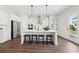 Modern kitchen with stainless steel appliances, a large island, and sleek white cabinetry with backyard access at 3698 Annsbury Ct, Lilburn, GA 30047