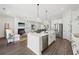 Bright, open floor plan with a kitchen island that overlooks the living room and fireplace at 3698 Annsbury Ct, Lilburn, GA 30047