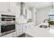 This modern kitchen features stainless steel appliances and white cabinets with dark hardware at 3698 Annsbury Ct, Lilburn, GA 30047