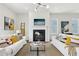 Bright living room featuring a fireplace, modern lighting, and neutral decor with a cozy seating arrangement at 3698 Annsbury Ct, Lilburn, GA 30047
