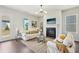 Bright and cozy living room with a fireplace, modern decor, and an abundance of natural light at 3698 Annsbury Ct, Lilburn, GA 30047