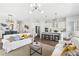 Bright, open-concept living space flows into a modern kitchen with a large island and stainless steel appliances at 3698 Annsbury Ct, Lilburn, GA 30047