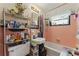Cozy bathroom featuring a bathtub, sink and storage shelves at 5335 Old Floyd Sw Rd, Mableton, GA 30126