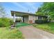 Ranch style home with covered porch, driveway, and mature trees at 5335 Old Floyd Sw Rd, Mableton, GA 30126