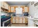 Functional kitchen with laminate flooring, modern appliances, and light cabinetry at 5335 Old Floyd Sw Rd, Mableton, GA 30126