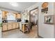Kitchen with laminate flooring, light wood cabinetry and view to living room at 5335 Old Floyd Sw Rd, Mableton, GA 30126