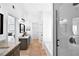 Open bathroom featuring granite countertops, sleek dark hardware, a walk-in shower, and a separate tub at 7375 Cavaletti Cir, Cumming, GA 30040
