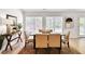 Dining room features a large dining table with seating for six, set upon a stylish, patterned rug at 7375 Cavaletti Cir, Cumming, GA 30040