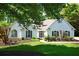Charming home with a manicured lawn, elegant black shutters, and a welcoming front entrance, creating a cozy curb appeal at 7375 Cavaletti Cir, Cumming, GA 30040