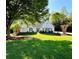 Charming one-story home with a well-manicured lawn and a beautiful, mature shade tree in the front yard at 7375 Cavaletti Cir, Cumming, GA 30040