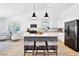 Modern kitchen with stainless steel appliances, granite countertops, and a breakfast bar with seating for three at 7375 Cavaletti Cir, Cumming, GA 30040