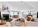 Open-concept living room with hardwood floors, brick fireplace, and an abundance of natural light at 7375 Cavaletti Cir, Cumming, GA 30040