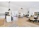 Spacious open-plan living area with hardwood floors connecting the kitchen, dining, and living spaces at 7375 Cavaletti Cir, Cumming, GA 30040