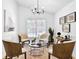 Bright living room featuring neutral tones, accent art, and a modern chandelier over a cozy seating area at 7375 Cavaletti Cir, Cumming, GA 30040