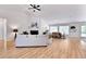 Bright living room featuring hardwood floors, vaulted ceiling, and seamlessly connects to the dining area at 7375 Cavaletti Cir, Cumming, GA 30040