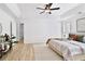 Bright main bedroom with hard wood flooring, tray ceilings, neutral walls, and a ceiling fan at 7375 Cavaletti Cir, Cumming, GA 30040