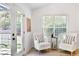 Cozy sun room filled with natural light, two comfortable armchairs and views of the private backyard at 7375 Cavaletti Cir, Cumming, GA 30040