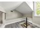 Finished attic with neutral walls, wood-look floors and built-in seating at 1009 Riverbend Club Se Dr, Atlanta, GA 30339