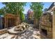 Stone backyard area featuring an outdoor fireplace, water feature and pergola at 1009 Riverbend Club Se Dr, Atlanta, GA 30339