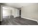 Neutral bedroom with wood floors, closet with mirror doors, and a white door at 1009 Riverbend Club Se Dr, Atlanta, GA 30339