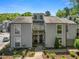 Charming townhome featuring a symmetrical facade, double front doors, and well-maintained landscaping at 1009 Riverbend Club Se Dr, Atlanta, GA 30339