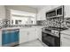 Bright kitchen features stainless appliances, mosaic backsplash, white cabinets and quartz countertops at 1009 Riverbend Club Se Dr, Atlanta, GA 30339