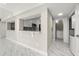 Open kitchen with a peek-through to the living area, stainless steel appliances, and white cabinetry at 1009 Riverbend Club Se Dr, Atlanta, GA 30339