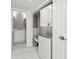 Convenient laundry area with a stacked washer and dryer, adjacent to a half bathroom for added functionality at 1009 Riverbend Club Se Dr, Atlanta, GA 30339