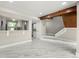 Bright living area with modern flooring, a staircase, and a pass-through to the kitchen at 1009 Riverbend Club Se Dr, Atlanta, GA 30339