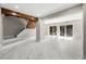 Open-concept living room with natural light, staircase, and sliding glass doors to the outside at 1009 Riverbend Club Se Dr, Atlanta, GA 30339