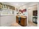 Bright kitchen features light wood cabinets, desk, and window at 5180 Chemin De Vie, Atlanta, GA 30342