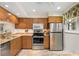 Modern kitchen with stainless appliances, light wood cabinetry, and granite countertops at 5180 Chemin De Vie, Atlanta, GA 30342