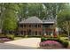 Stately brick home with manicured landscaping, mature trees, and a circular driveway at 5790 Heards Forest Dr, Atlanta, GA 30328