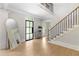 Grand foyer with hardwood floors, staircase, and a view of the front door and entry at 5790 Heards Forest Dr, Atlanta, GA 30328