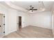 Bright bedroom showcases hardwood floors, modern wall paneling detail, and entry to the en suite bath at 255 Briscoe Way # 5, Alpharetta, GA 30009