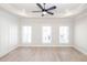 Spacious bedroom featuring hardwood floors, large windows, a tray ceiling, and neutral paint colors at 255 Briscoe Way # 5, Alpharetta, GA 30009