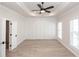Bright bedroom boasts hardwood floors, large windows, and modern wall paneling detail at 255 Briscoe Way # 5, Alpharetta, GA 30009