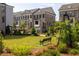 A serene green space with a bench offers a relaxing spot amidst the elegant brick townhomes at 255 Briscoe Way # 5, Alpharetta, GA 30009