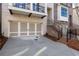 A close up of the garage with a concrete driveway and brick stairs at 255 Briscoe Way # 5, Alpharetta, GA 30009