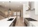 Open-concept kitchen with stainless steel appliances, island, and access to the living area at 255 Briscoe Way # 5, Alpharetta, GA 30009