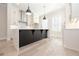 Bright kitchen features white cabinets, modern fixtures and a center island at 255 Briscoe Way # 5, Alpharetta, GA 30009