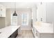 Modern kitchen boasts white cabinets, stainless steel appliances, and light hardwood floors at 255 Briscoe Way # 5, Alpharetta, GA 30009