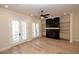 Bright living room features modern fireplace, built-in shelves, hardwood floors and french doors to balcony at 255 Briscoe Way # 5, Alpharetta, GA 30009
