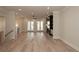 Open-concept living room with hardwood floors, bright light, and French doors to the porch at 255 Briscoe Way # 5, Alpharetta, GA 30009