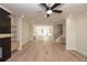 Open-concept living space showcases hardwood floors, modern fireplace, stairs to the upper floor, and kitchen at 255 Briscoe Way # 5, Alpharetta, GA 30009