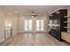 Bright living room featuring a dark fireplace, light hardwood floors, and french doors to a balcony at 255 Briscoe Way # 5, Alpharetta, GA 30009
